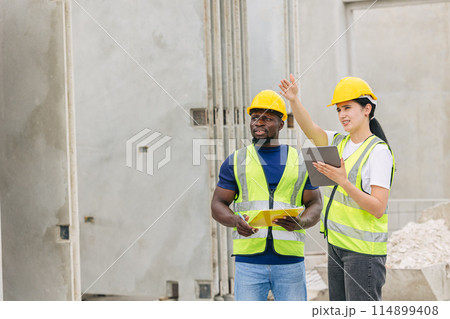 Engineer smart women working contact with African black worker in Precast concrete casting manufacturing company site inspector 114899408
