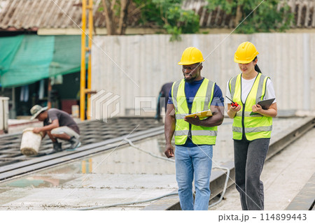 Engineer smart women working contact with African black worker in Precast concrete casting manufacturing company site inspector Engineer smart women working contact with African black worker in Precast concrete casting manufacturing company site inspector 114899443