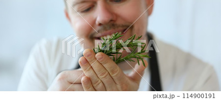 Smiling Chef Holding Green Rosemary Herb Bunch Smiling Chef Holding Green Rosemary Herb Bunch 114900191