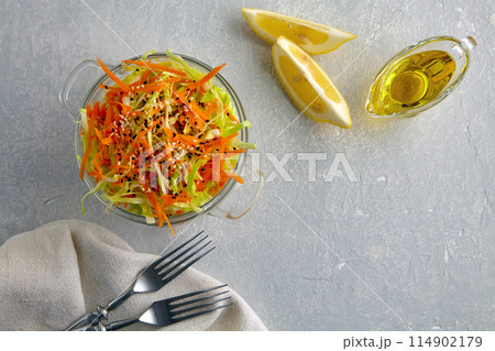 Vegetarian healthy salad of raw vegetables cabbage and carrots with sesame seeds, dressed with olive oil and lemon juice Vegetarian healthy salad of raw vegetables cabbage and carrots with sesame seeds, dressed with olive oil and lemon juice 114902179