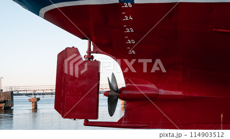 A red ship with a propeller on the side 114903512
