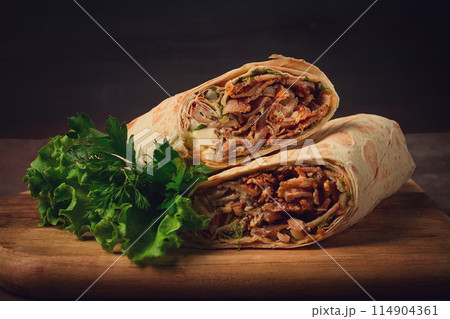 cut shawarma, 2 pieces, on a cutting board, close-up, 114904361
