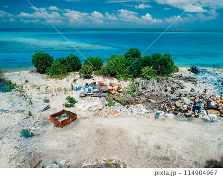 Rubbish dump and blue sea in Maldives. Ecological problem. Drone view Rubbish dump and blue sea in Maldives. Ecological problem. Drone view 114904967