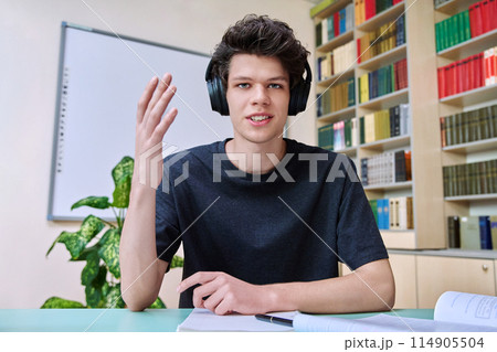 Web cam portrait of college student guy in headphones looking talking to camera Web cam portrait of college student guy in headphones looking talking to camera 114905504
