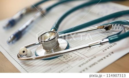 Health insurance card with a bill and stethoscope, key for covering medical costs. 114907313