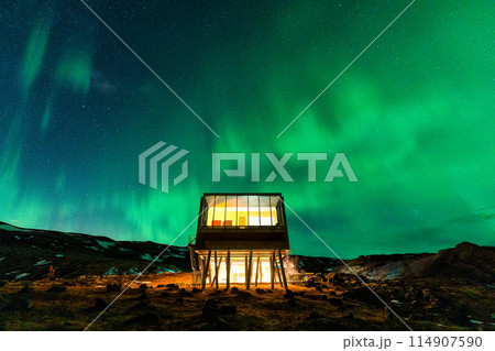 Aurora borealis, Northern lights glowing over luxury hotel on volcanic wilderness in winter at Iceland Aurora borealis, Northern lights glowing over luxury hotel on volcanic wilderness in winter at Iceland 114907590