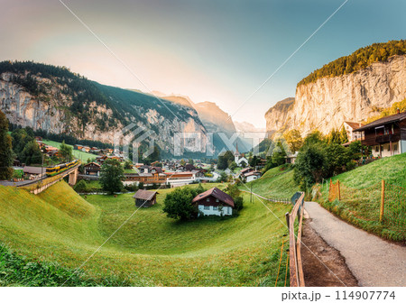 Lauterbrunnen valley with rustic village, famous church and Staubbach falls in the morning at Switzerland 114907774