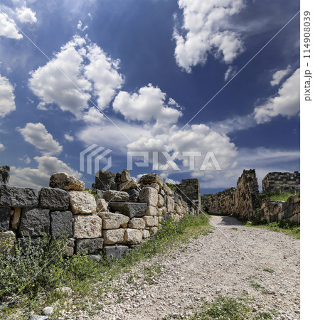 Roman ruins at Umm Qais (Umm Qays)--is a town in northern Jordan near the site of the ancient town of Gadara, Jordan. Against the background of a beautiful sky with clouds Roman ruins at Umm Qais (Umm Qays)--is a town in northern Jordan near the site of the ancient town of Gadara, Jordan. Against the background of a beautiful sky with clouds 114908039