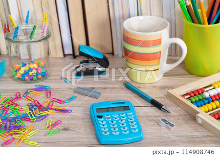 Office accessories necessary for learning. The paper clips are on the desk. School materials. Office accessories necessary for learning. The paper clips are on the desk. School materials. 114908746