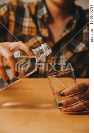 healthy beautiful young woman holding glass of water 114909257
