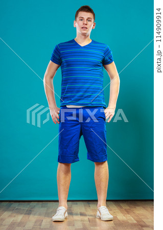 Young man portrait on blue Young man portrait on blue 114909914