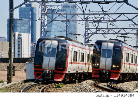 名鉄名古屋本線を走る特急電車と名古屋駅のビル群 114914594