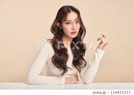 Beautiful young asian woman with clean fresh skin on beige background, Face care, Facial treatment, Cosmetology, beauty and spa, Asian women portrait. 114915313