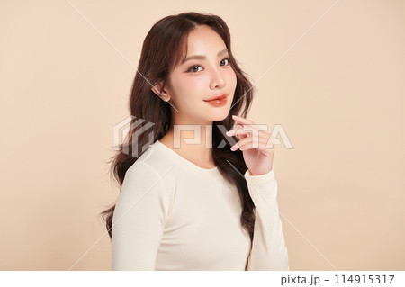 Beautiful young asian woman with clean fresh skin on beige background, Face care, Facial treatment, Cosmetology, beauty and spa, Asian women portrait. 114915317