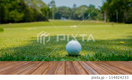 Wooden floor and golf course background. Fresh spring green golf course with wood floor. Beauty natural background, Empty wooden deck table with Green background. 114924233