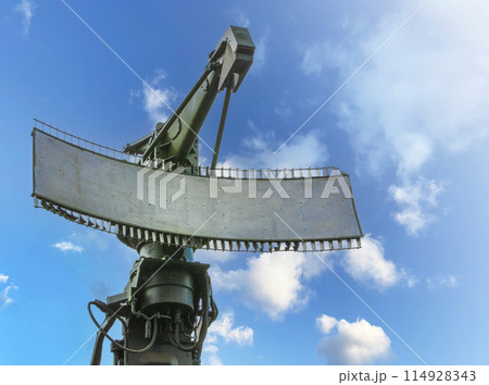 Green Military radar station against blue sky on sunlight 114928343