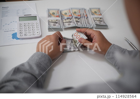 Unrecognisable businessman, accountant, banker counting money at the workplace, white background 114928564