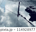 水たまりに映る空と電線 114928977
