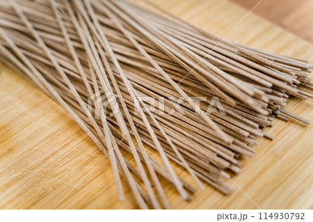Cutting board with raw japanese buckwheat pasta Cutting board with raw japanese buckwheat pasta 114930792