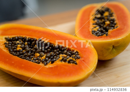 Chef cuts and peels papaya on the cutting board 114932836