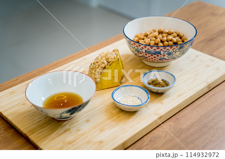 Cutting board with ingredients for preparing chickpea porridge with ginger Cutting board with ingredients for preparing chickpea porridge with ginger 114932972