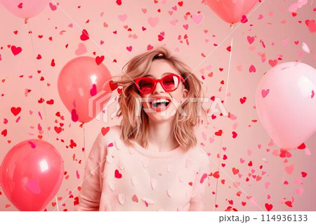 Happy young woman in heart shaped glasses celebrating Valentine's day with balloons and confetti on pink background Happy young woman in heart shaped glasses celebrating Valentine's day with balloons and confetti on pink background 114936133