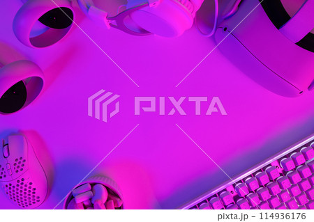 Modern gaming gadgets on purple desk Modern gaming gadgets on purple desk 114936176