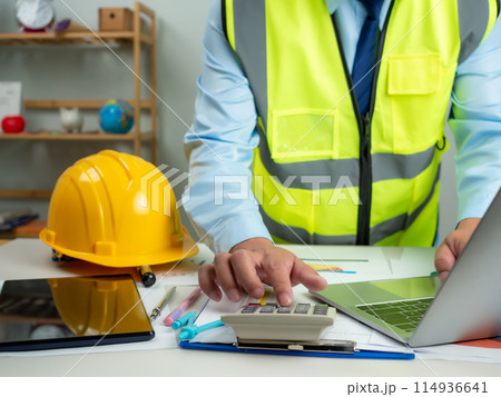 Architect or engineer using computer to work on desk, Cost calculation, Construction planning, Structural calculation, Construction cost planning, Structural design, Project presentation plan. Architect or engineer using computer to work on desk, Cost calculation, Construction planning, Structural calculation, Construction cost planning, Structural design, Project presentation plan. 114936641