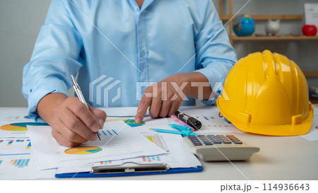 Architect or engineer sitting at desk in office, Cost calculation, Construction planning, structural calculation, Project construction cost planning and calculation, Project presentation plan. Architect or engineer sitting at desk in office, Cost calculation, Construction planning, structural calculation, Project construction cost planning and calculation, Project presentation plan. 114936643