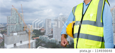 Civil engineer architect standing holding a safety helmet on construction site background, Construction site plans to build high-rise buildings, Engineer building concept, Background for construction. Civil engineer architect standing holding a safety helmet on construction site background, Construction site plans to build high-rise buildings, Engineer building concept, Background for construction. 114936648