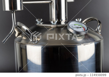 brand new stainless steel alcohol machine on black background brand new stainless steel alcohol machine on black background 114938099