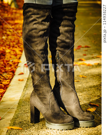 Woman wearing black knee high boots Woman wearing black knee high boots 114938227