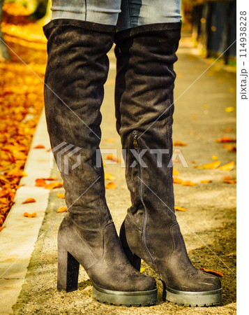 Woman wearing black knee high boots 114938228