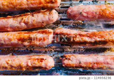 Sausages meat grilling on gas grill 114938236