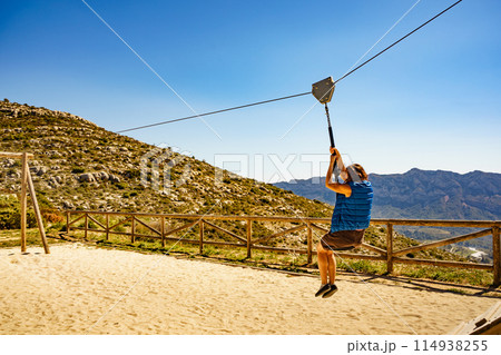 Adult woman having fun on zipline 114938255