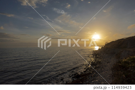 Sunset over the water against sunlight on the Black Sea Sunset over the water against sunlight on the Black Sea 114939423