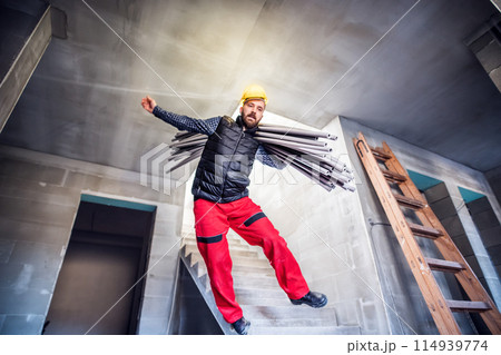 Man falling off the ladder. Accident of a man worker at the construction site. Work injury, accident in workplace. 114939774