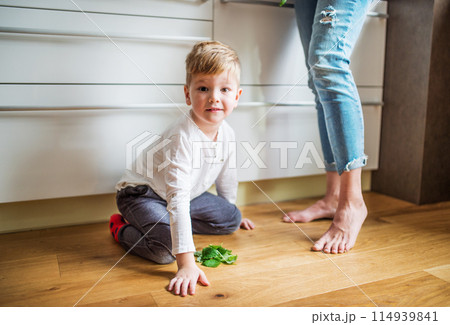 Grandma takes care of the grandchildren while parents are at work, spending time in kitchen, cooking together and having fun. Grandma takes care of the grandchildren while parents are at work, spending time in kitchen, cooking together and having fun. 114939841