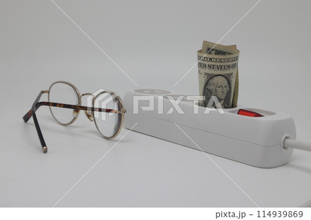 White electric cable and banknotes, expensive electricity, saving electricity. 114939869