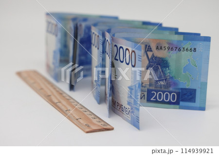 The wooden ruler lies on the background of several banknotes, the control and planning of finances The wooden ruler lies on the background of several banknotes, the control and planning of finances 114939921