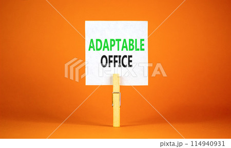 Adaptable office symbol. Concept words Adaptable office on beautiful white paper on wooden clothespin. Beautiful orange background. Business Adaptable office concept. Copy space. 114940931