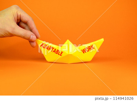 Adaptable work symbol. Concept words Adaptable work on beautiful yellow paper boat. Beautiful orange paper background. Businessman hand. Business Adaptable work concept. Copy space. Adaptable work symbol. Concept words Adaptable work on beautiful yellow paper boat. Beautiful orange paper background. Businessman hand. Business Adaptable work concept. Copy space. 114941026