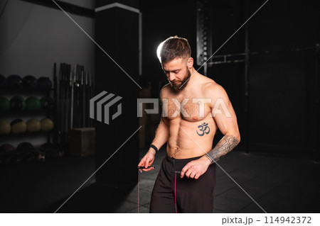 Man jumping rope, doing double-unders as part of daily workout. Routine workout for physical and mental health. Man jumping rope, doing double-unders as part of daily workout. Routine workout for physical and mental health. 114942372