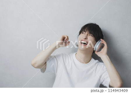 音楽を聴く若い男性　 114943409