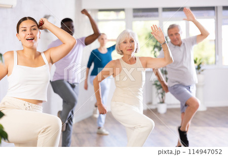 Young girl dance instructor conducting class for adults Young girl dance instructor conducting class for adults 114947052
