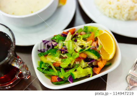 Choban salad from tomatoes, cucumbers, greens, onions with lemon Choban salad from tomatoes, cucumbers, greens, onions with lemon 114947219