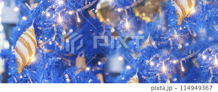 Banner Blurred Background Blue Christmas tree decorated gold bauble ornament in holiday winter xmas bokeh light. Panorama backdrop Gold light Blue christmas tree in cozy living room with copy space Banner Blurred Background Blue Christmas tree decorated gold bauble ornament in holiday winter xmas bokeh light. Panorama backdrop Gold light Blue christmas tree in cozy living room with copy space 114949367