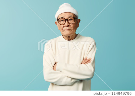 Serious elderly man looking determined with arms crossed Serious elderly man looking determined with arms crossed 114949796