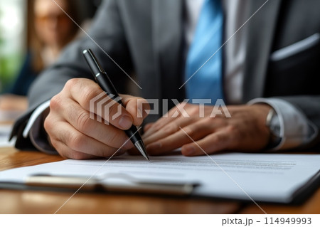 Corporate executive filling out paperwork 114949993