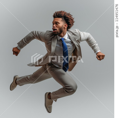 Businessman with fly-away tie in mid-air leap Businessman with fly-away tie in mid-air leap 114951476